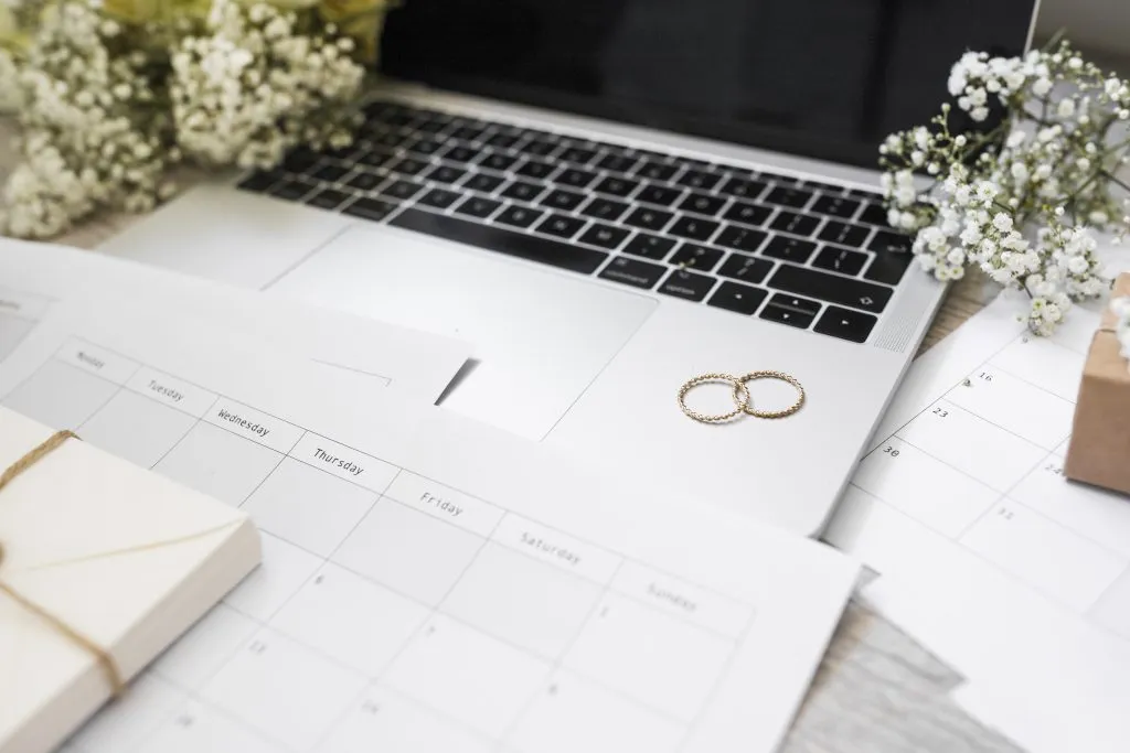Planning an event timeline with a notebook and a phone on the table