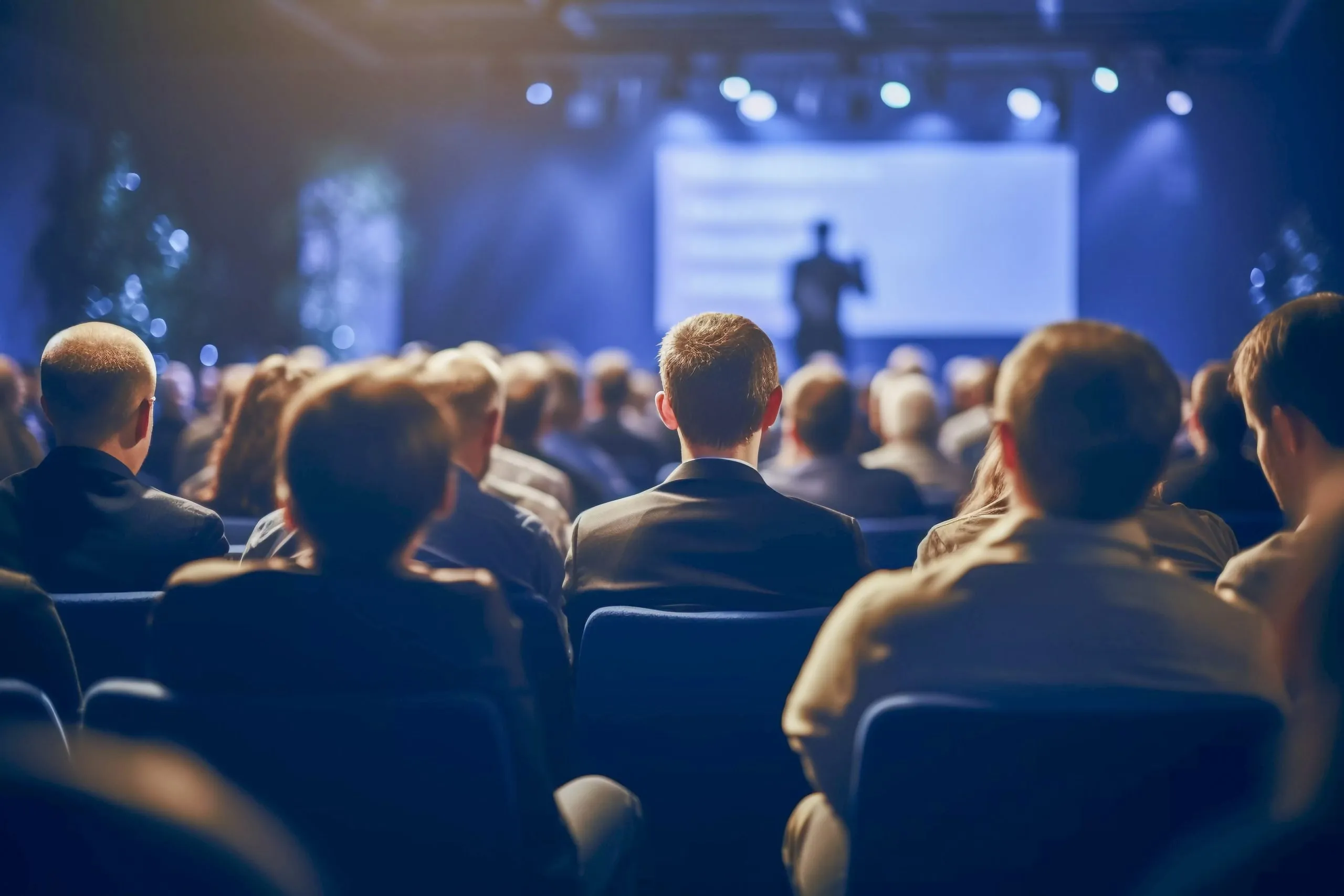 Audience at a corporate conference watching the main stage